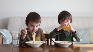 kids eating healthy noodles at home