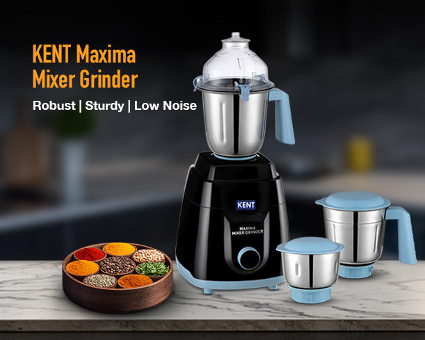 Kent Maxima Mixer Grinder with multiple jars, stainless steel blades, and control knobs, shown on a kitchen countertop.