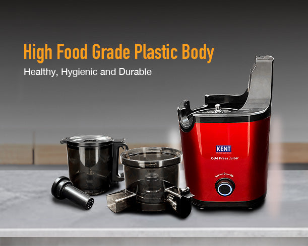 Kent Cold Pressed Juicer by Kent RO Systems shown on a countertop with fruit and vegetables ready for juicing.